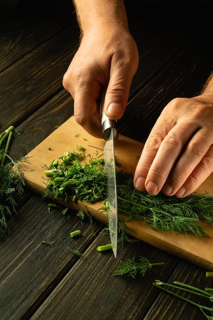 Hands slicing fresh herbs